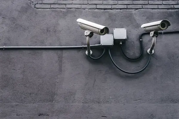 Security Camera mounted to dark grey exterior wall