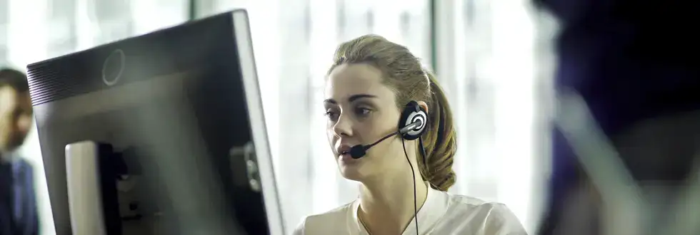 Young IT Service Desk Operator on call