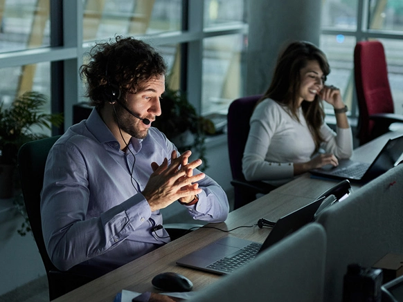 IT staff working in a darkened modern office space late at night