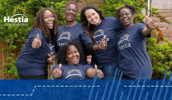 Hestia staff members in a group smiling and laughing