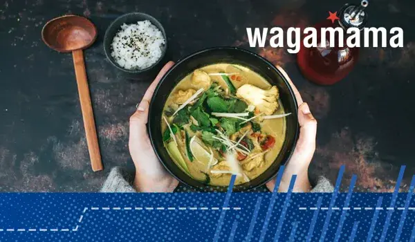 wagamama dish held in two hands next to condiments