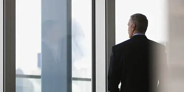 Business professional staring out of window